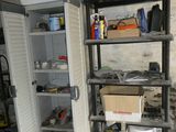 an open refrigerator in the middle of a room with tools