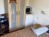 a bed in a small room with a wooden headboard