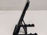 a black tablet on a stand on a white surface