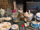 a table that has a lot of dishes and cups on it