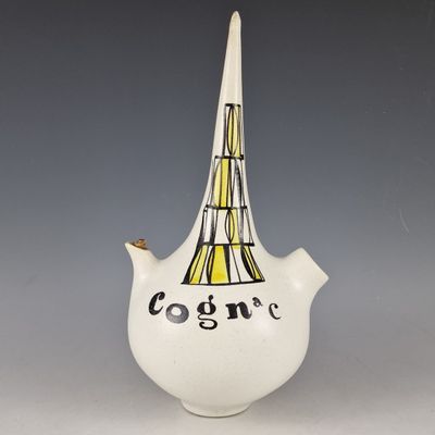 a white vase with a black and yellow design on it
