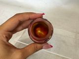 a person holding a cup of tea in their hand