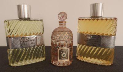 trois flacons de parfum posés les uns à côté des autres sur une table