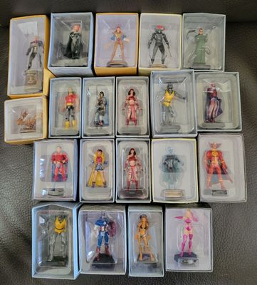a lot of action figures in the boxes on the couch