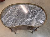 a marble top table with a gold trim around it