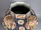 a vase with a floral design on it on a table