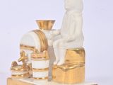 a small statue of a man sitting on a box
