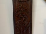 a wooden plaque on the wall next to a mirror