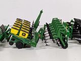 a lot of toy farm equipment on a white surface