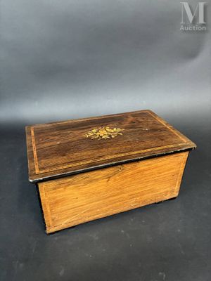 an old wooden box with a gold decoration on the lid