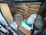 the inside of a van with a bunch of items in the back