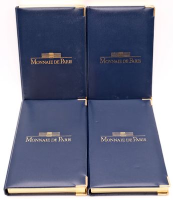 two blue books sitting on top of each other on a white surface