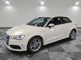 a white audi is parked in a room with a checkered floor