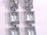 two pairs of earrings with blue topaz and white topaz stones