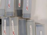 a lot of small plastic containers with pens in them