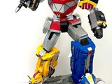 a statue of a robot with a sword on top of a table