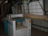 a machine that is sitting inside of a building with a hose attached to it