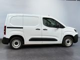 the white van is parked in a room with a gray floor