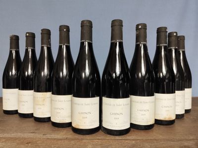 six bottles of wine are lined up on a wooden table