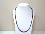 multicolored beaded necklace on a mannequin with a white mannequin