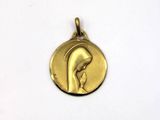 a close up of a gold medal with a woman ' s face on it