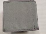 someone is holding a gray wallet on a white surface