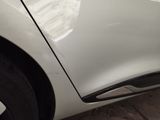 a close up of a car door handle with a sticker on it