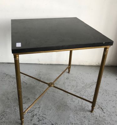 une table d'appoint noire et dorée avec un plateau noir