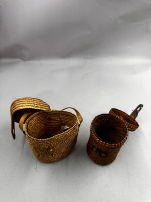 two baskets with handles and handles are sitting on a white surface