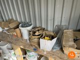 many boxes and buckets on a shelf in a storage area
