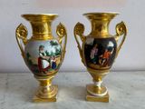 two vases that are sitting on a table