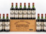 a group of six bottles of wine in a wooden crate