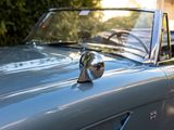 a close up of a car with a mirror on it ' s hood