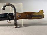 a close up of a knife with a wooden handle
