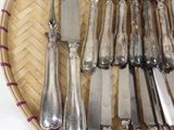 a lot of silverware in a basket on the table