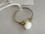 a ring with a white stone on it and a price tag attached to it