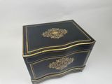 a black and gold jewelry box sitting on top of a white surface