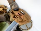 a pair of boots and a bag sitting on the floor