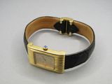 a watch that is sitting on a black leather band