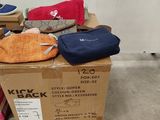 a pile of shoes and bags on a pallet next to a wall