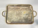an old metal tray with handles and handles on a white surface