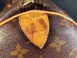 a close up of a louis vuitton bag with a tag on it