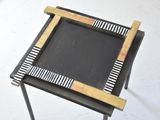 a small table with a black and white design on it