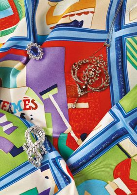 a close up of a colorful scarf with a broochet on it