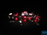 a bunch of red diamonds on a black surface