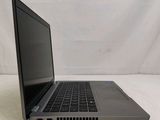 an open laptop computer sitting on top of a white surface