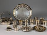 an assortment of silverplated items including a bowl, tray, cups, and other items