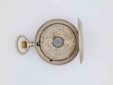 a silver pocket watch on a white surface with a white background