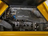 a small engine in the back of a yellow car