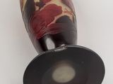 a vase with a flower design on it sitting on a table